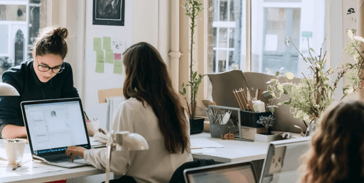 Miland agents collaborating at a shared office desk