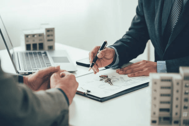 Client and agent finalising a property agreement over the keys