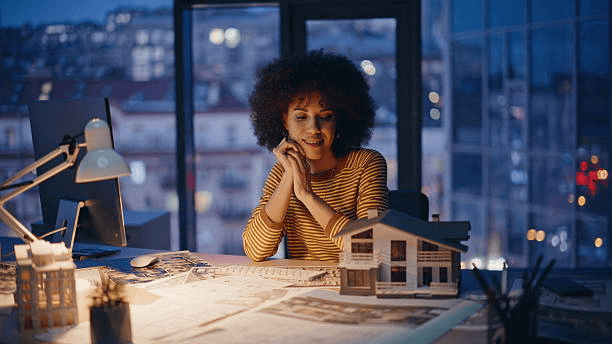 Client reviewing a model home in an evening office